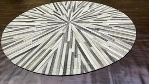Handmade Starburst Cowhide Rug: Round Patchwork Leather Carpet with Wool Backing - Alef home