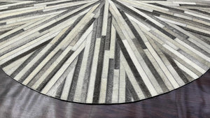 Handmade Starburst Cowhide Rug: Round Patchwork Leather Carpet with Wool Backing - Alef home