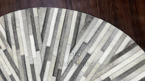 Handmade Starburst Cowhide Rug: Round Patchwork Leather Carpet with Wool Backing - Alef home