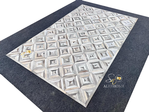 Handmade Grey Cowhide Patchwork Area Rug: Geometric Hair-On Leather Carpets For Home - Alef home