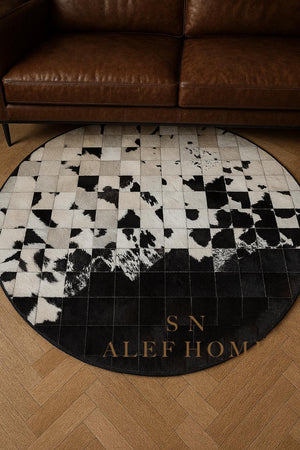 Handmade Cowhide Patchwork Rug: Round Black & White Leather Carpet - Alef home