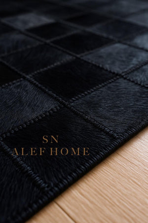 Black Cowhide Checkerboard Rug: Handmade Hair-On Leather Patchwork Carpet - Alef home
